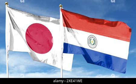 Flaggen von Japan und Paraguay. Im blauen Himmel winken Stockfoto