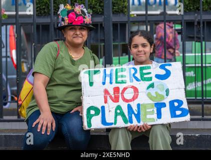 London, Großbritannien. Juni 2024. Mutter und Tochter von Umweltschützern halten ein Schild bei der Demonstration von Restore Nature Now in London und rufen zu dringenden politischen Maßnahmen in Bezug auf Natur- und Klimakrisen auf. Stockfoto