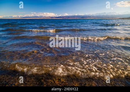 Ultra-Weitwinkelblick auf kleine Wellen auf dem Bergsee an sonnigen Tagen. Flachwinkelansicht. Stockfoto