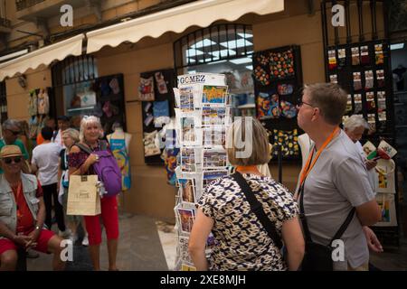 26. Juni 2024, Malaga, Spanien: Touristen sehen sich Fotos vor einem Souvenirladen in der Innenstadt an, vor dem Hintergrund der zunehmenden Ablehnung des Massentourismus. Malaga hat einen deutlichen Anstieg des Massentourismus und eine Zunahme der Zahl der Touristenwohnungen im Stadtzentrum und in den Vierteln erlebt. Diese Faktoren haben zu steigenden Miet- und Wohnungspreisen geführt. Lokale Nachbarschaftsverbände und -Organisationen fordern Maßnahmen zur Begrenzung der Mietpreise und der Auswirkungen des Massentourismus. (Credit Image: © Jesus Merida/SOPA Images via ZUMA Press Wire) EDI Stockfoto