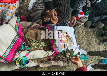 Traditionelles Ritual der Zahlung an die Erde mit Kokablättern und Chicha de jora in den Anden der Bergkette an einem sonnigen Tag Stockfoto