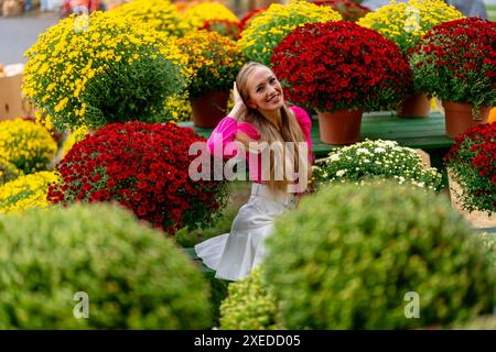 Ein hübsches blondes europäisches Model genießt es, Blumen für die Halloween-Feiertage zu kaufen Stockfoto