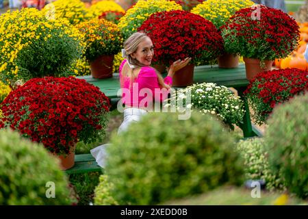 Ein hübsches blondes europäisches Model genießt es, Blumen für die Halloween-Feiertage zu kaufen Stockfoto