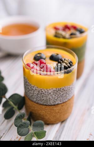 Gesunder veganer Chia-Pudding mit Mangohauce und frischen Beeren Stockfoto