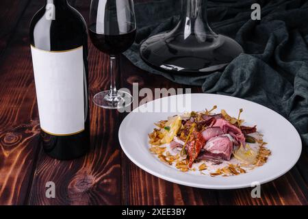 Italienisches Vitello Tonnato mit Flasche und Glas Wein Stockfoto