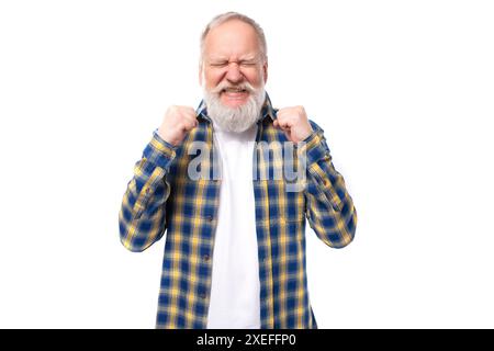 Seniorenpensionär, grauhaariger Mann mit Bart in Hemd träumt, seine Augen auf weißem Hintergrund zu bedecken Stockfoto