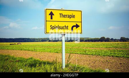 Ein Bild mit einem Wegweiser, der in zwei verschiedene Richtungen auf Deutsch zeigt. Eine Richtung deutet auf Spielsucht hin, die andere auf Therapie. Stockfoto