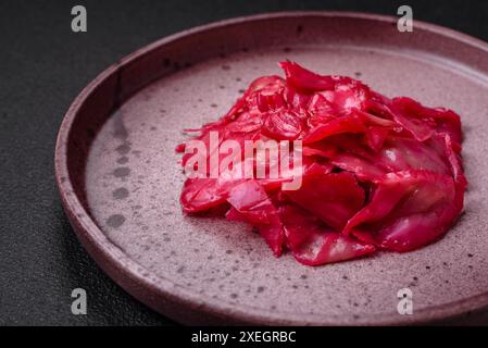 Köstlicher scharfer rosafarbener Kohl in Scheiben geschnitten und auf einer Keramikplatte im koreanischen Stil gekocht Stockfoto