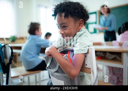 Lehrer und Schüler lernen und lernen in einem Klassenzimmer der Schule, in dem Kinder sitzen und aufmerksam zuhören. Stockfoto