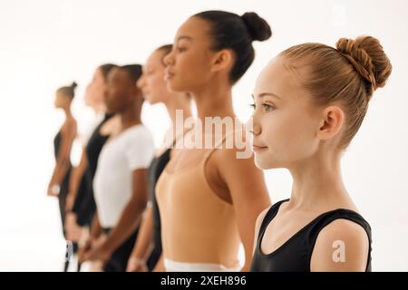 Ballett-, kreativ- und Tanzschüler, die mit einem Lehrer oder Lehrer in der Klasse oder Kunstschule trainieren und lernen. Mädchen, Teamwork oder Tänzerinnen tanzen Stockfoto