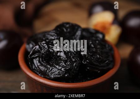 Leckere getrocknete Pflaumen (Pflaumen) in der Schüssel auf dem Tisch, Nahaufnahme Stockfoto