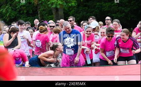 Brighton UK 29 Juni 2024 - Tausende nehmen an einem warmen sonnigen Tag im Stanmer Park Brighton am Cancer Research UK Pretty Muddy Race for Life Teil. Teilnehmer, die von Krebs berührt wurden, finden ihren Weg um den hübschen Muddy Hindernislauf, der etwas mehr als 3 Meilen entfernt ist und hilft, Tausende von Pfund für Cancer Research UK zu sammeln: Credit Simon Dack / Alamy Live News Stockfoto