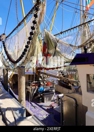 Garnelenschneider mit Fischernetzen im Hafen von Greetsiel, bereit für den nächsten Fang. Fischernetze in der Sonne. Stockfoto