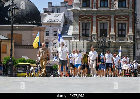 LEMBERG, UKRAINE - 30. JUNI 2024 - finnische Freiwillige, die innerhalb von 42 Tagen 1.561 Kilometer von Helsinki nach Lemberg gelaufen sind und im Rahmen des Wohltätigkeitswegs Relay to Ukraine mehr als 180.000 Euro für Krankenwagen und medizinische Ausrüstung für die Ukraine gesammelt haben, absolvieren ihre Reise in Lemberg, Westukraine. Stockfoto