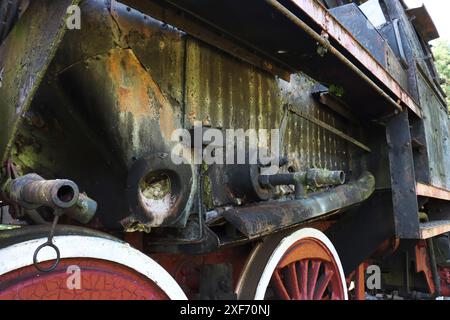 Fahrgestell einer alten Dampflokomotive. Fahrgestell einer alten Dampflokomotive... Ein Bruchstück der Seite und des Fahrgestells einer verlassenen Retro-Lokomotive. Stockfoto