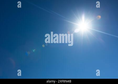 Linseneffekt über tiefblauem Himmel mit strahlender Sonne Stockfoto