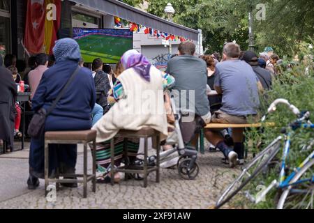 Gäste vor einer Bar in der Reichenberger Straße in Berlin-Kreuzberg verfolgen das Spiel Türkei gegen Portugal anlässlich der Fußballeuropameisterschaft UEFA EURO 2024. / Gäste vor einer Bar in der Reichenberger Straße in Berlin-Kreuzberg sehen das Spiel zwischen der Türkei und Portugal während der Fußball-Europameisterschaft UEFA EURO 2024. Schnappschuss-Fotografie/K.M.Krause *** Gäste vor einer Bar in der Reichenberger Straße in Berlin Kreuzberg sehen das Spiel zwischen der Türkei und Portugal während der Fußball-Europameisterschaft UEFA EURO 2024 Gäste vor einer Bar in der Reichenberger Straße in B Stockfoto