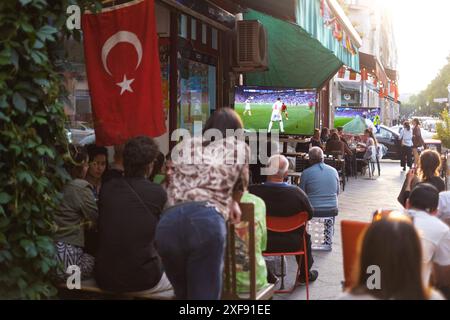 Gäste vor einer Bar in der Naunynstraße in Berlin-Kreuzberg verfolgen das Spiel Türkei gegen Portugal anlässlich der Fußballeuropameisterschaft UEFA EURO 2024. / Gäste vor einer Bar in der Naunynstraße in Berlin-Kreuzberg sehen das Spiel zwischen der Türkei und Portugal während der Fußball-Europameisterschaft UEFA EURO 2024. Schnappschuss-Fotografie/K.M.Krause *** Gäste vor einer Bar in der Naunynstraße in Berlin Kreuzberg sehen das Spiel zwischen der Türkei und Portugal während der Fußball-Europameisterschaft UEFA EURO 2024 Gäste vor einer Bar in der Naunynstraße in Berlin Kreuzberg sehen das Spiel Stockfoto