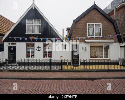 Zwei traditionelle Häuser mit verzierten Fassaden und einer Kopfsteinpflasterstraße vor dem Hotel, urk, niederlande Stockfoto