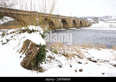 Ein Winterblick auf die Brücke über den Fluss Tyne in Corbridge, Northumberland. Die älteste noch erhaltene Brücke über den Tyne. Stockfoto