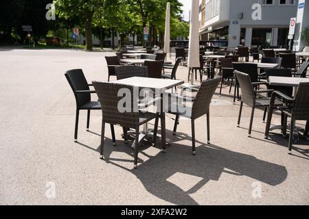 Leere Tische vor einem Café laden an einem sonnigen Tag zum Sitzen ein, sich auszuruhen und einen Drink oder Essen zu sich zu nehmen. Niedrige Tiefe von fi Stockfoto