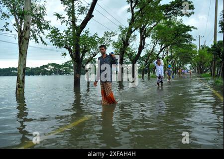 Die Menschen laufen durch das Hochwasser in der Gobindogonj - Chhatak Straße des Sunamgonj Bezirks der Sylhet Division. Bangladesch. Stockfoto