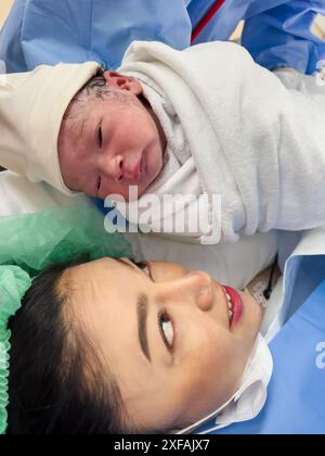 Erstaufnahme von Mutter und neugeborenem Kind nach Kaiserschnitt im OP Stockfoto