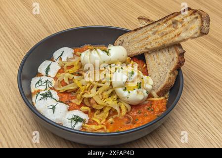 Das Gericht mit gebrochenen Eiern hat vermutlich seinen Ursprung in der andalusischen Küche, Stockfoto