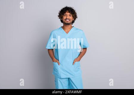 Foto eines selbstbewussten, positiven Arztes, der Hände in einheitlichem, isoliertem pastellfarbenen Hintergrund hält Stockfoto
