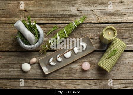 Flache Lagenkomposition mit Räucherstäbchen schwelend in Halter auf Holztisch Stockfoto