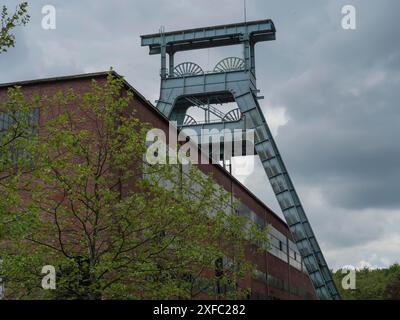 Historischer Wendeturm neben einem alten Backsteinbau mit grüner Vegetation im Vordergrund, Herten, Nordrhein-Westfalen, Deutschland Stockfoto