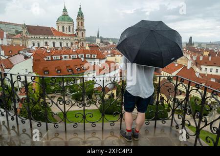 Prag, Tschechische Republik. Juli 2024. Touristen mit einem Regenschirm beobachten die Stadtlandschaft des historischen Zentrums von Prag bei bewölktem Wetter. Das historische Zentrum von Prag ist Teil des UNESCO-Weltkulturerbes der Organisation der Vereinten Nationen für Bildung, Wissenschaft und Kultur. (Foto: Tomas Tkacik/SOPA Images/SIPA USA) Credit: SIPA USA/Alamy Live News Stockfoto