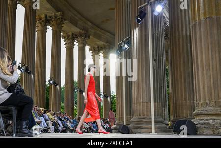 Potsdam, Deutschland. Juli 2024. Modelle zeigen Kreationen des Labels Marc Cain in den Kolonnaden mit dem Triumphtor im Neuen Palais. Die Modeschau ist Teil der Berlin Fashion Week. Quelle: Jens Kalaene/dpa/Alamy Live News Stockfoto