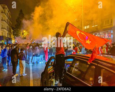 Türkische Fans machen in Bruchsal nach EM-Viertelfinaleinzug die Nacht zum Tag: Hunderte Türkei-Fans belagern Straße vor dem Bahnhof in Bruchsal und feiern den türkischen Sieg über Österreich lautstarke Siegesfeier mit Bengalos, Fahnen und Musik nach dem überraschenden Einzug der türkischen Nationalmannschaft ins Viertelfinale der UEFA EM 2024 sind die türkischen Fans in Deutschland kaum noch zu halten. In Bruchsal brach nach dem Schlusspfiff wortwörtlich die Hölle los und die Bahnhofstraße verwandelte sich wie beim Einzug ins Achtelfinale in einer riesigen Partyzone. Hunderte Türkei-Anhänger ve Stockfoto