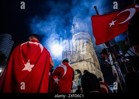 Berlin, Deutschland. Juli 2024. Fußball: Europameisterschaft, Österreich - Türkei, Endrunde, Achtelfinale. Türkei-Fans feiern den Sieg am Breitscheidplatz mit Pyrotechnik vor der Kaiser-Wilhelm-Gedächtniskirche. Quelle: Christoph Soeder/dpa/Alamy Live News Stockfoto