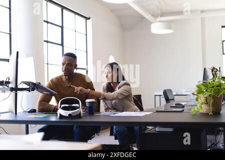 Zusammenarbeit am Projekt, Kollegen diskutieren über die Arbeit am Schreibtisch in modernen Büros Stockfoto