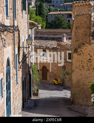 Atemberaubende Stadtlandschaft der kleinen Küstenort Deia auf Mallorca, Spanien. Traditionelle Häuser in Terrassen auf den Hügeln umgeben von grünen Bäumen entfernt Stockfoto