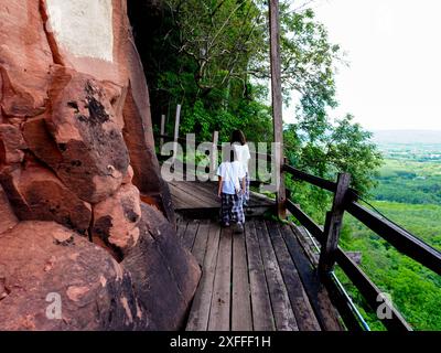 Touristenmädchen laufen auf Holzbrücken in Phu Thok oder Wat Chetiyakhiri, wunderschöne Berglandschaft, Provinz Bueng Kan, Thailand. Stockfoto