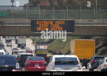 Ein Schild mit extremer Hitze, kühl bleiben, Wasser trinken auf einer Tafel am Interstate 105 Freeway, 2. Juli 2024, in Los Angeles. Stockfoto