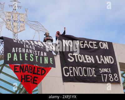 4. Juli 2024, Australien, Canberra, Parlamentsgebäude. Pro-palästinensische Demonstranten klettern auf das Dach des australischen Parlaments, um Banner zu entfalten, die die Rolle der australischen Regierung bei der Förderung des Völkermords in Gaza kritisieren Stockfoto