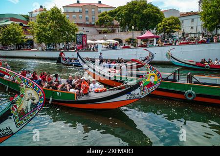 Die malerischen Boote gleiten entlang der malerischen Kanäle von Aveiro, oft auch als „Venedig von Portugal“ bezeichnet, und zeigen den einzigartigen Charme und das maritime Erbe der Stadt. Stockfoto