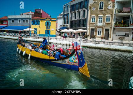 Die malerischen Boote gleiten entlang der malerischen Kanäle von Aveiro, oft auch als „Venedig von Portugal“ bezeichnet, und zeigen den einzigartigen Charme und das maritime Erbe der Stadt. Stockfoto