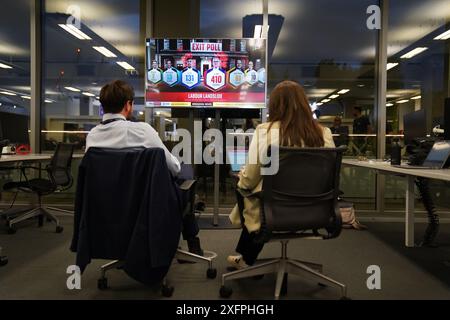 Medienvertreter im Zentrum Londons beobachten eine Austrittsumfrage, die der Labour Party einen Erdrutschsieg bei den Parlamentswahlen 2024 bescherte. Bilddatum: Donnerstag, 4. Juli 2024. Stockfoto