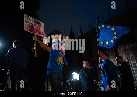 London, Großbritannien. Juli 2024. Ein Mitglied der Öffentlichkeit mit einem Schild, auf dem steht: „Die Tories haben ihre CHIPS bekommen! SUNAKERED!“ Laut der Austrittsumfrage steuert Labour bei den britischen Parlamentswahlen auf einen Erdrutschsieg zu. Quelle: David Tramontan / Alamy Live News Stockfoto