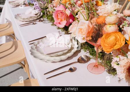 Leuchtende Blumen und farbenfrohe Umgebung auf dem Hochzeitstisch Stockfoto