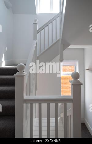 Renovierte, weiß lackierte Holztreppe mit einfachen vertikalen Leisten, in einem edwardianischen Haus im Nordwesten Londons, Großbritannien. Stockfoto
