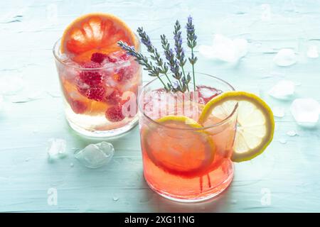 Sommercocktails oder Mocktails, kalte Getränke mit Zitrusfrüchten und Lavendel, Party-Limonade auf blauem Hintergrund Stockfoto