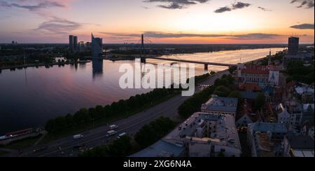 Blick aus der Vogelperspektive auf Riga bei Sonnenuntergang mit Daugava und Hängebrücke Stockfoto