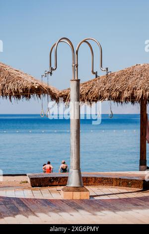 Öffentliche Freiluftdusche am Strand in Eilat, Israel. Rotes Meer im Hintergrund. Wunderschöne Aussicht. Erfrischende Körper nach Salzwasser Stockfoto