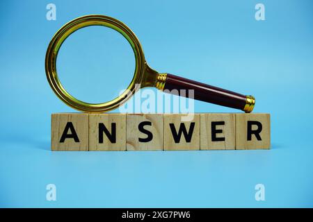 Antworten Sie mit Holzblöcken Buchstaben und Vergrößerungsglas auf blauem Hintergrund Stockfoto